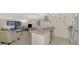 Open-concept living space with modern kitchen, living room furniture and stainless steel appliances at 1618 Stickney Point Rd # 101, Sarasota, FL 34231