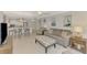 Bright, open-concept layout with a living room featuring comfy seating and seamless flow into a modern kitchen and dining area at 1618 Stickney Point Rd # 101, Sarasota, FL 34231
