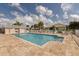 Community swimming pool featuring a tanning ledge and an array of lounge chairs for relaxation at 1669 Monarch Dr # 201, Venice, FL 34293