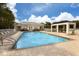 Community pool featuring a large pool, a covered lounge area, and several lounge chairs on a sunny day at 1669 Monarch Dr # 201, Venice, FL 34293