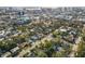 Aerial view of a residential neighborhood with lush greenery and a city skyline at 1723 5Th St, Sarasota, FL 34236