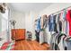 Bright closet featuring hardwood floors, shelving, and ample hanging space for clothing organization at 1723 5Th St, Sarasota, FL 34236