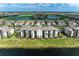 Aerial view showcasing the condo building amidst lush green landscapes, golf courses, and serene water bodies within the community at 18008 Gawthrop Dr # 308, Bradenton, FL 34211