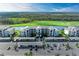 An aerial view of a condo community overlooking a golf course and water feature with covered parking and beautiful landscaping at 18008 Gawthrop Dr # 308, Bradenton, FL 34211