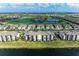 Scenic aerial view of a lakeside community featuring condos, golf course, and lush landscaping on a sunny day at 18008 Gawthrop Dr # 308, Bradenton, FL 34211