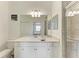 Modern bathroom with glass enclosed shower, bright vanity, and view to the bedroom at 18008 Gawthrop Dr # 308, Bradenton, FL 34211