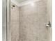 Modern bathroom shower featuring gray tiling and a shower head, providing a sleek and clean design at 18008 Gawthrop Dr # 308, Bradenton, FL 34211