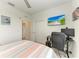 Bedroom showcasing a TV, closet, desk and computer setup, offering functionality and entertainment at 18008 Gawthrop Dr # 308, Bradenton, FL 34211