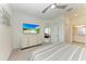 Bright bedroom with queen bed, ceiling fan, large dresser, and view to living room and bath at 18008 Gawthrop Dr # 308, Bradenton, FL 34211