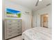 Bedroom view featuring a dresser, closet, and an open door leading to the bathroom at 18008 Gawthrop Dr # 308, Bradenton, FL 34211