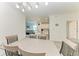 Open-concept dining area with a contemporary table set, seamlessly flowing into the living room and kitchen at 18008 Gawthrop Dr # 308, Bradenton, FL 34211