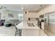 Bright, open-concept kitchen and living area featuring a large island with seating and stainless steel appliances at 18008 Gawthrop Dr # 308, Bradenton, FL 34211