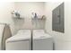 Bright laundry room with a washer, dryer, and storage shelves, providing a functional space at 18008 Gawthrop Dr # 308, Bradenton, FL 34211