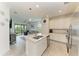 Open-concept living area featuring an island with seating, stainless steel appliances, and views of the lanai at 18008 Gawthrop Dr # 308, Bradenton, FL 34211