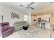 Open living room with fan, gray sofa, view of the kitchen and backyard at 18008 Gawthrop Dr # 308, Bradenton, FL 34211
