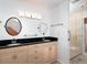 Bathroom features a double sink vanity, granite countertop, and a glass door shower at 1838 Sandalwood Dr, Sarasota, FL 34231