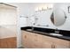Bathroom showcasing dual sinks, granite countertop, and convenient access to a walk-in closet at 1838 Sandalwood Dr, Sarasota, FL 34231