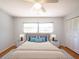 Comfortable bedroom with a ceiling fan, light-filled window, and a closet with shutter doors at 1838 Sandalwood Dr, Sarasota, FL 34231