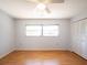 Well-lit bedroom with a ceiling fan, a window letting in natural light, and a closet with shutter doors at 1838 Sandalwood Dr, Sarasota, FL 34231
