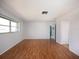 Bright bedroom with wood floors, a large window, and plenty of open space at 1838 Sandalwood Dr, Sarasota, FL 34231