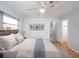 Bedroom featuring a ceiling fan, wood floors, and a view of the backyard through the window at 1838 Sandalwood Dr, Sarasota, FL 34231