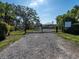 Community entrance with gate, driveway, and lush landscaping at 1838 Sandalwood Dr, Sarasota, FL 34231