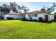 Beautiful view of a home with green lawn and well-maintained landscaping at 1838 Sandalwood Dr, Sarasota, FL 34231