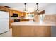 Bright kitchen featuring wooden cabinetry, modern appliances, and a spacious countertop bar at 1838 Sandalwood Dr, Sarasota, FL 34231