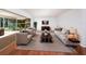 Open living room filled with natural light, furnished with plush seating, and a sliding glass door at 1838 Sandalwood Dr, Sarasota, FL 34231