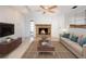 Living room featuring a classic stone fireplace with a wood mantel, a ceiling fan, and neutral tones at 1838 Sandalwood Dr, Sarasota, FL 34231