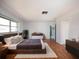 Spacious main bedroom featuring a large window, wood floors, and modern furnishings at 1838 Sandalwood Dr, Sarasota, FL 34231