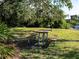 Community picnic table surrounded by lush greenery at 1838 Sandalwood Dr, Sarasota, FL 34231