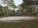 Community playground with swings and play structure surrounded by trees and natural beauty at 1838 Sandalwood Dr, Sarasota, FL 34231