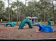 Community playground with colorful animal climbing structures and natural landscaping at 1838 Sandalwood Dr, Sarasota, FL 34231