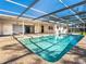 Refreshing swimming pool surrounded by a covered patio and a lush backyard at 1838 Sandalwood Dr, Sarasota, FL 34231