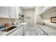 Well-equipped laundry room with granite countertops, white cabinets, and modern washer/dryer at 20 Bayhead Ln, Osprey, FL 34229