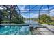 Gorgeous screened pool with a jacuzzi overlooks a tranquil pond with a beautiful fountain at 20 Bayhead Ln, Osprey, FL 34229