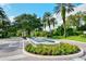 Elegant entrance with a decorative fountain and lush landscaping leads to a stately community building at 20 Bayhead Ln, Osprey, FL 34229