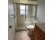 Bathroom featuring a glass-enclosed shower, tiled walls, and a granite-topped vanity at 2105 Pueblo Cir # V2, Sarasota, FL 34231