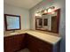 This bathroom features granite countertops, dark wood cabinets, and dual mirrors over a spacious vanity at 2105 Pueblo Cir # V2, Sarasota, FL 34231