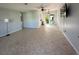 An open-concept living area boasts tile flooring and a sliding glass door for natural light and easy access to the backyard at 2105 Pueblo Cir # V2, Sarasota, FL 34231