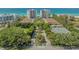 Aerial view of high rise condos featuring lush landscaping, tennis court, and a beach view at 2301 Gulf Of Mexico Dr # 33N, Longboat Key, FL 34228