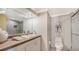 Bright bathroom with a modern vanity, tile floors and walk-in shower at 2301 Gulf Of Mexico Dr # 33N, Longboat Key, FL 34228
