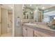 Well-lit bathroom with a tiled vanity and shower/tub combination at 2301 Gulf Of Mexico Dr # 33N, Longboat Key, FL 34228
