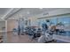 Community gym with weights, stationary bike, mirror wall, ocean view, and rubber flooring at 2301 Gulf Of Mexico Dr # 33N, Longboat Key, FL 34228