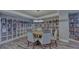 Community library featuring floor to ceiling book shelves and a table with chairs at 2301 Gulf Of Mexico Dr # 33N, Longboat Key, FL 34228