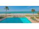 Community pool with pristine lounge seating and beach views at 2301 Gulf Of Mexico Dr # 33N, Longboat Key, FL 34228