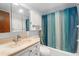 Bathroom featuring a vanity and a shower-tub combo with blue and white curtains at 2326 Canal Dr # G25, Bradenton, FL 34207