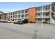 Multi-level condo building featuring ample parking spaces and colorful accent at 2326 Canal Dr # G25, Bradenton, FL 34207