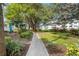 Walking path with lush landscaping and well-maintained lawn leading toward the condos at 2326 Canal Dr # G25, Bradenton, FL 34207